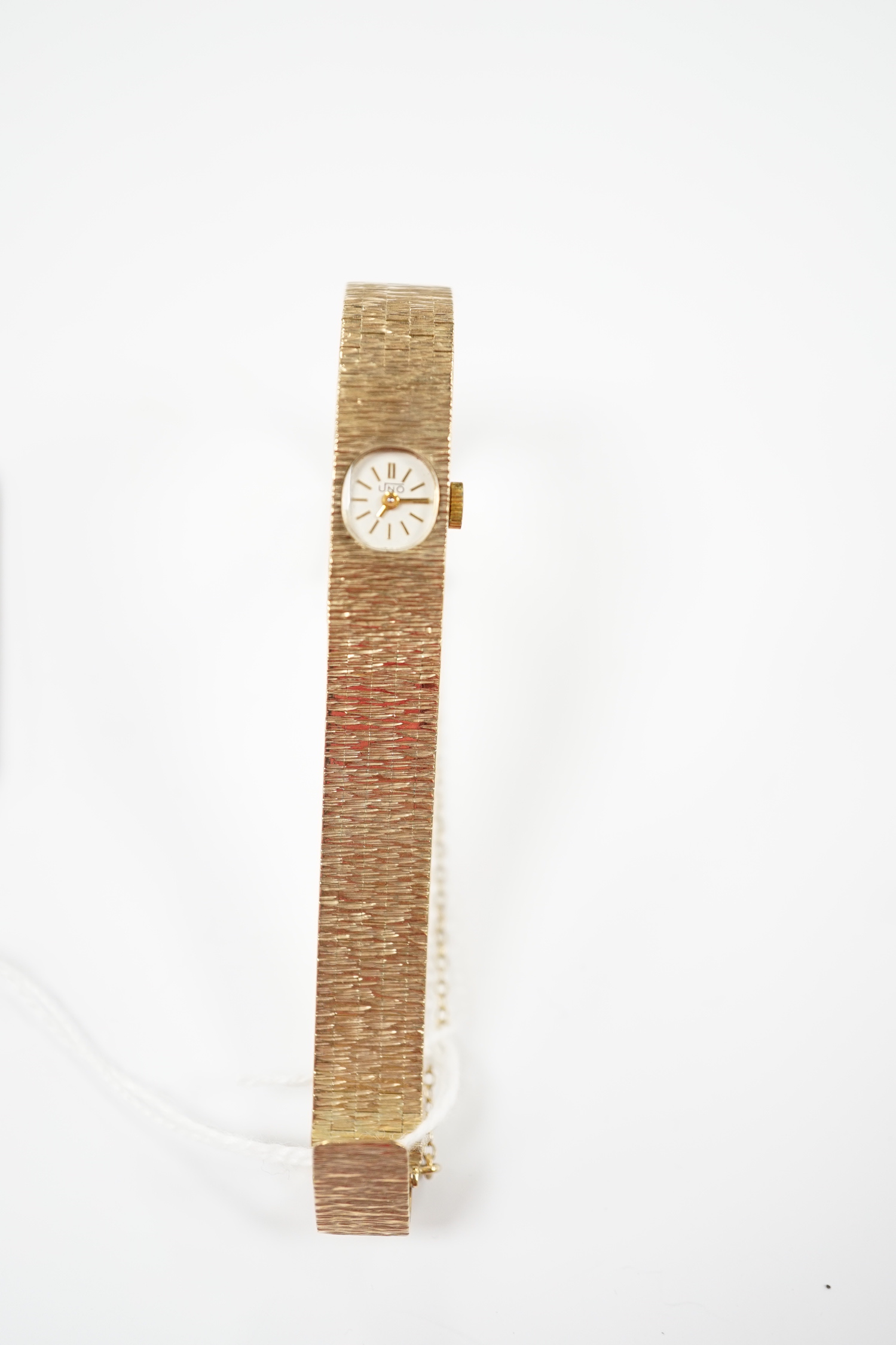 A lady's 1970's 9ct. gold Uno manual wind bracelet wrist watch with a bark textured bracelet, gross weight 24.8 grams.